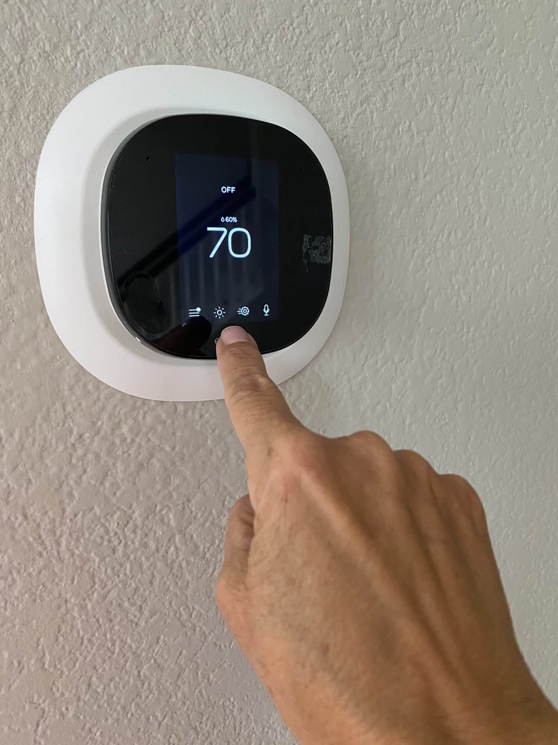 a homeowner and woman adjusts the settings and tem 2022 11 01 02 03 07 utc (1)