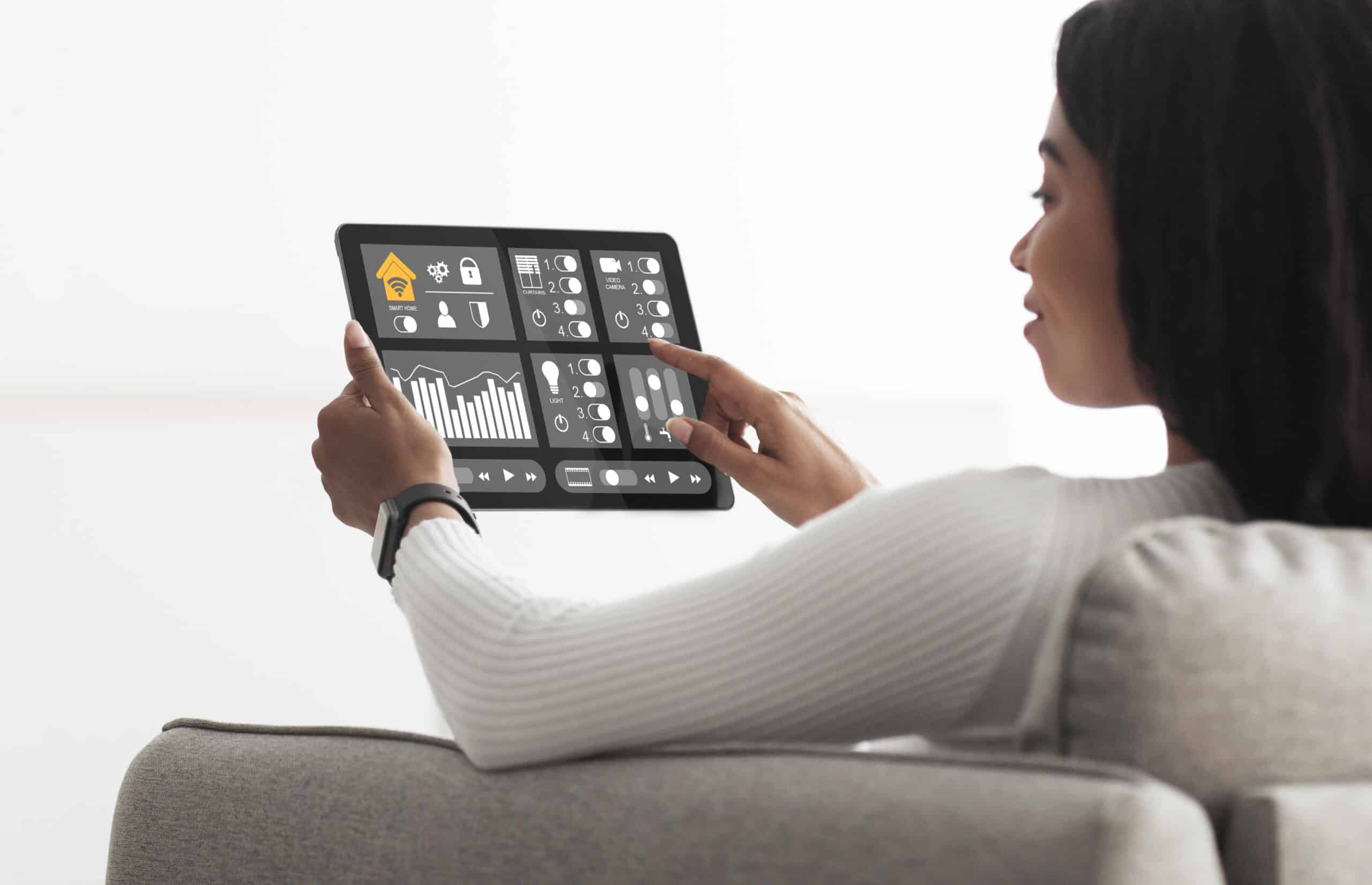 african american woman using smart home automation assistant