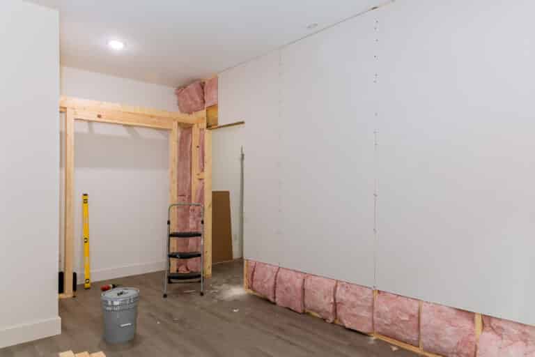 after installing thermal and sound insulation for a new home, the drywall is screwed to the walls on the beams framing