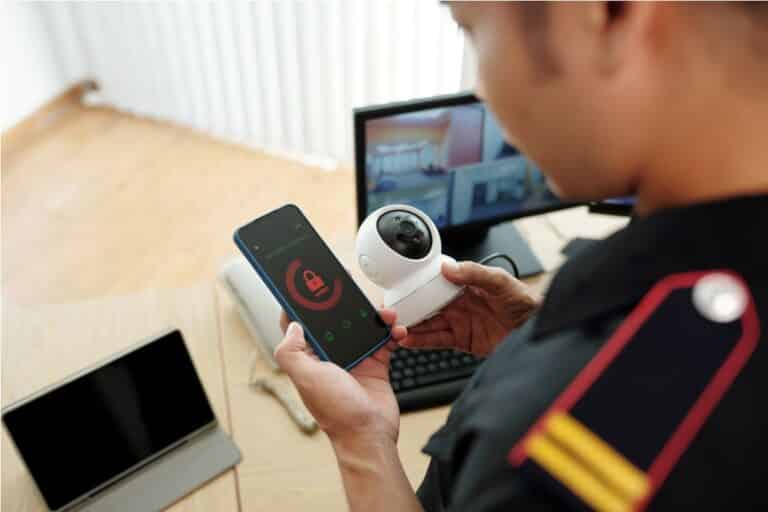 security guard connecting surveillance camera to mobile application