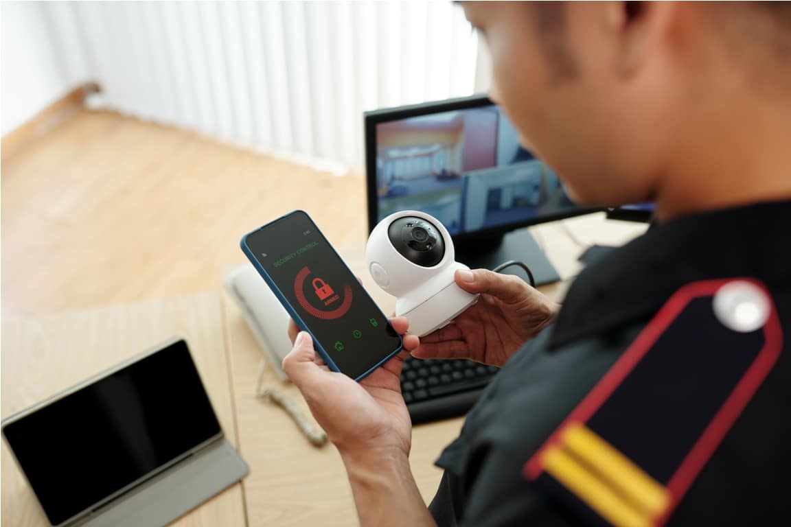 security guard connecting surveillance camera to mobile application