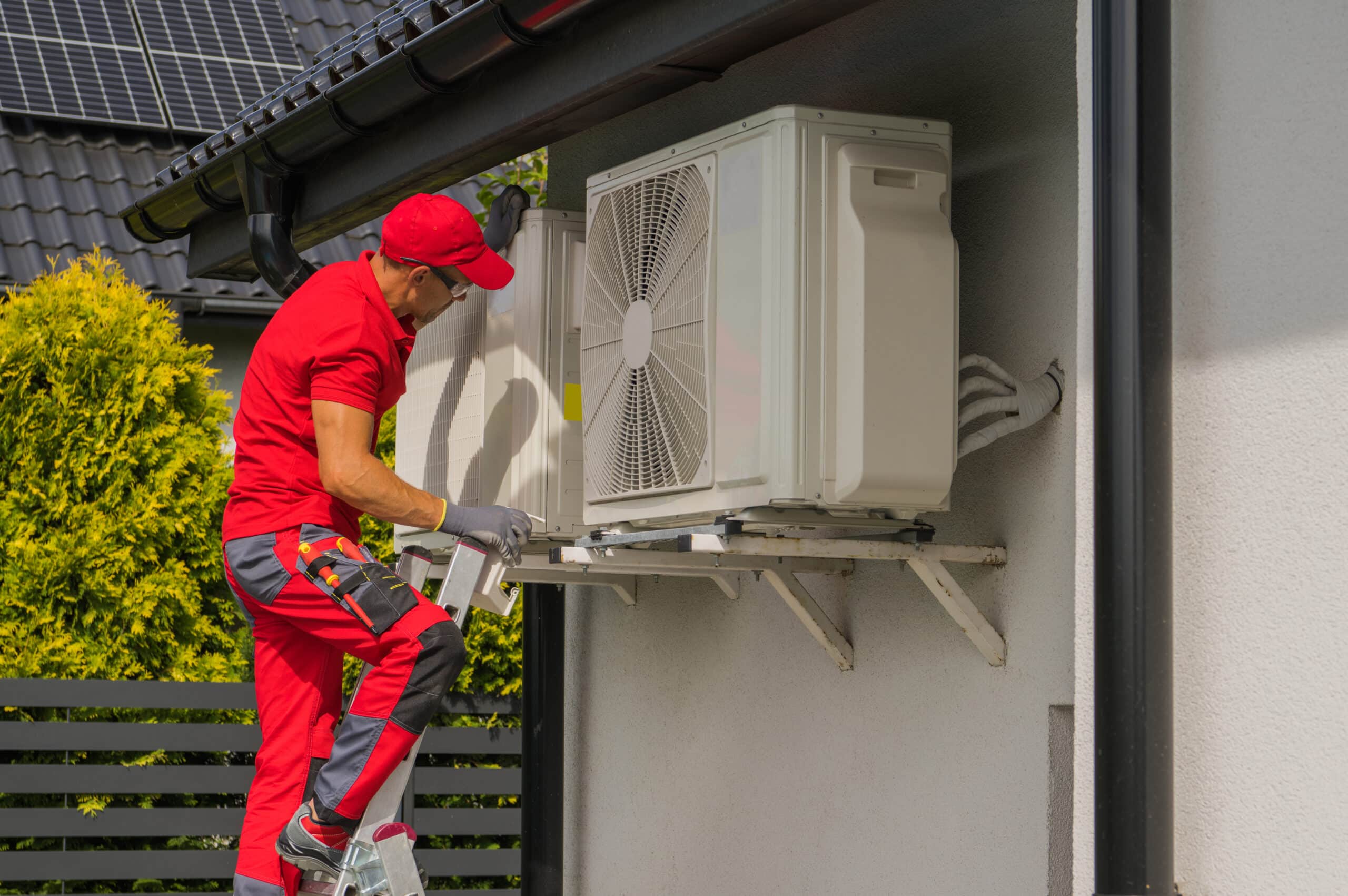 hvac worker performing heat pump and air condition units seasona