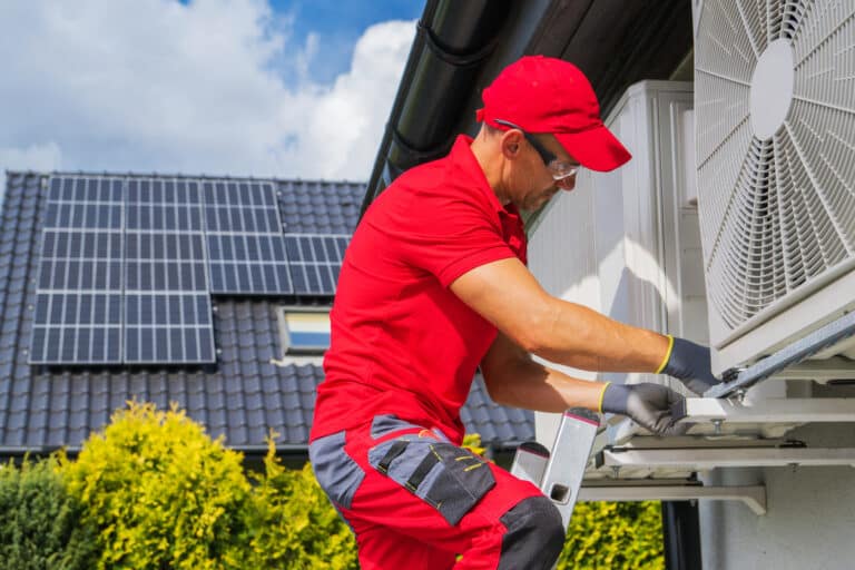 hvac worker performing heat pump maintenance