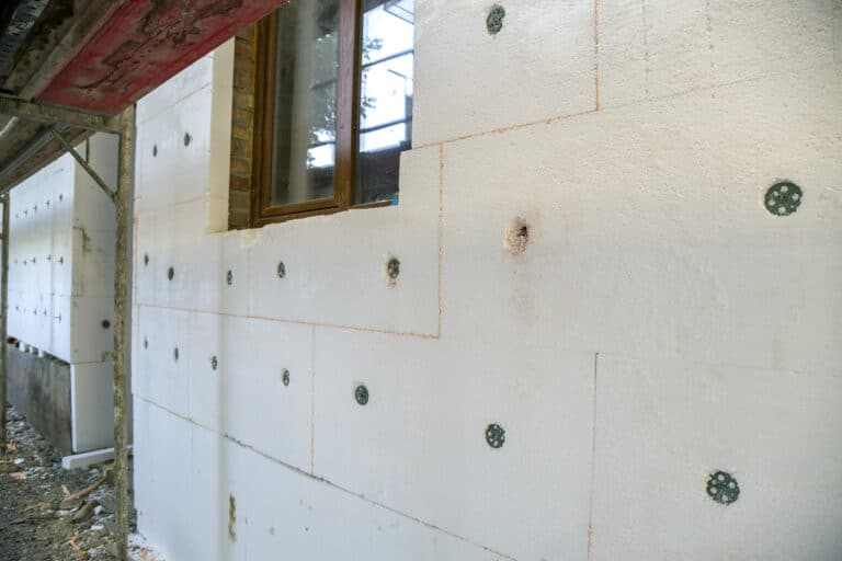 insulation work of house walls with styrofoam sheets.