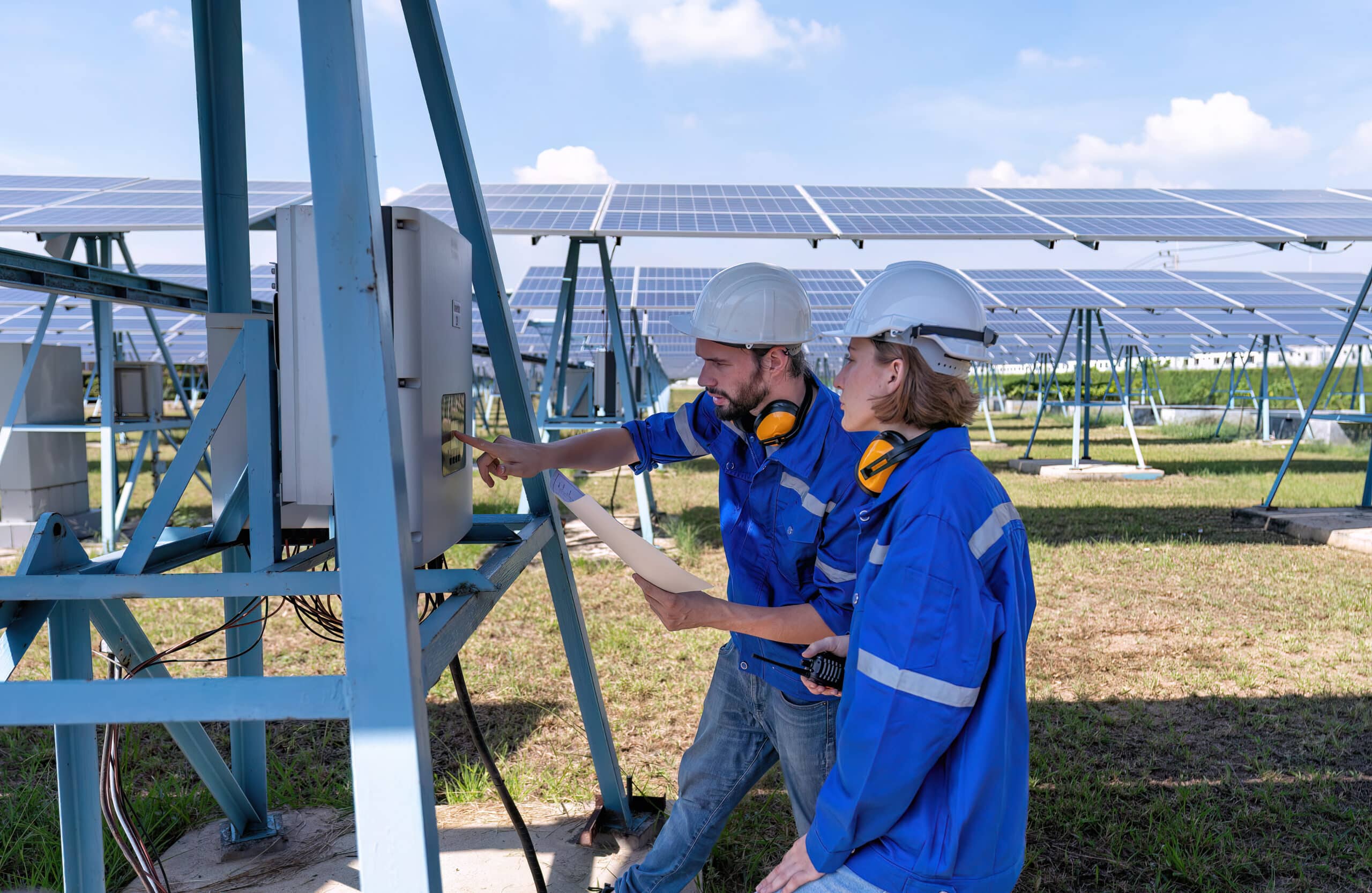 maintenance engineer at solar farm trouble shooting looking at inverter control panel malfunction