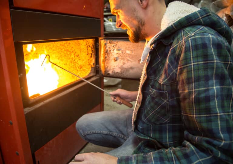people working in the boiler on solid fuel