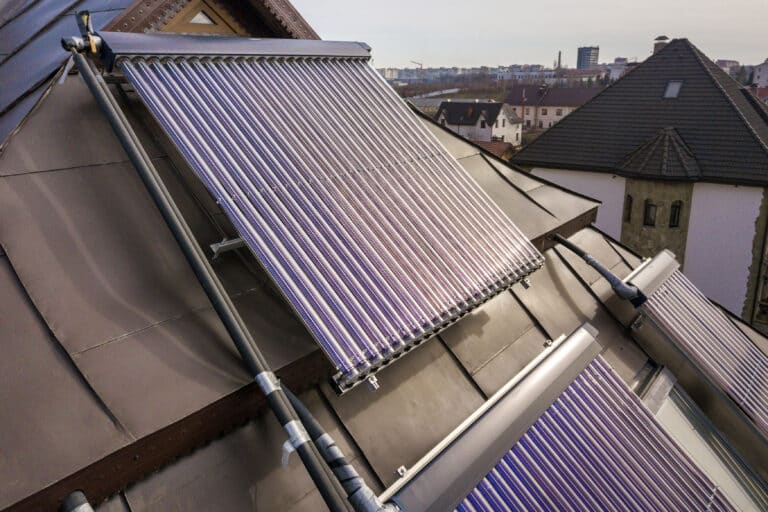 solar water heating system on house roof. hot water boiler, alternative ecological sun energy generator. modern technology concept.