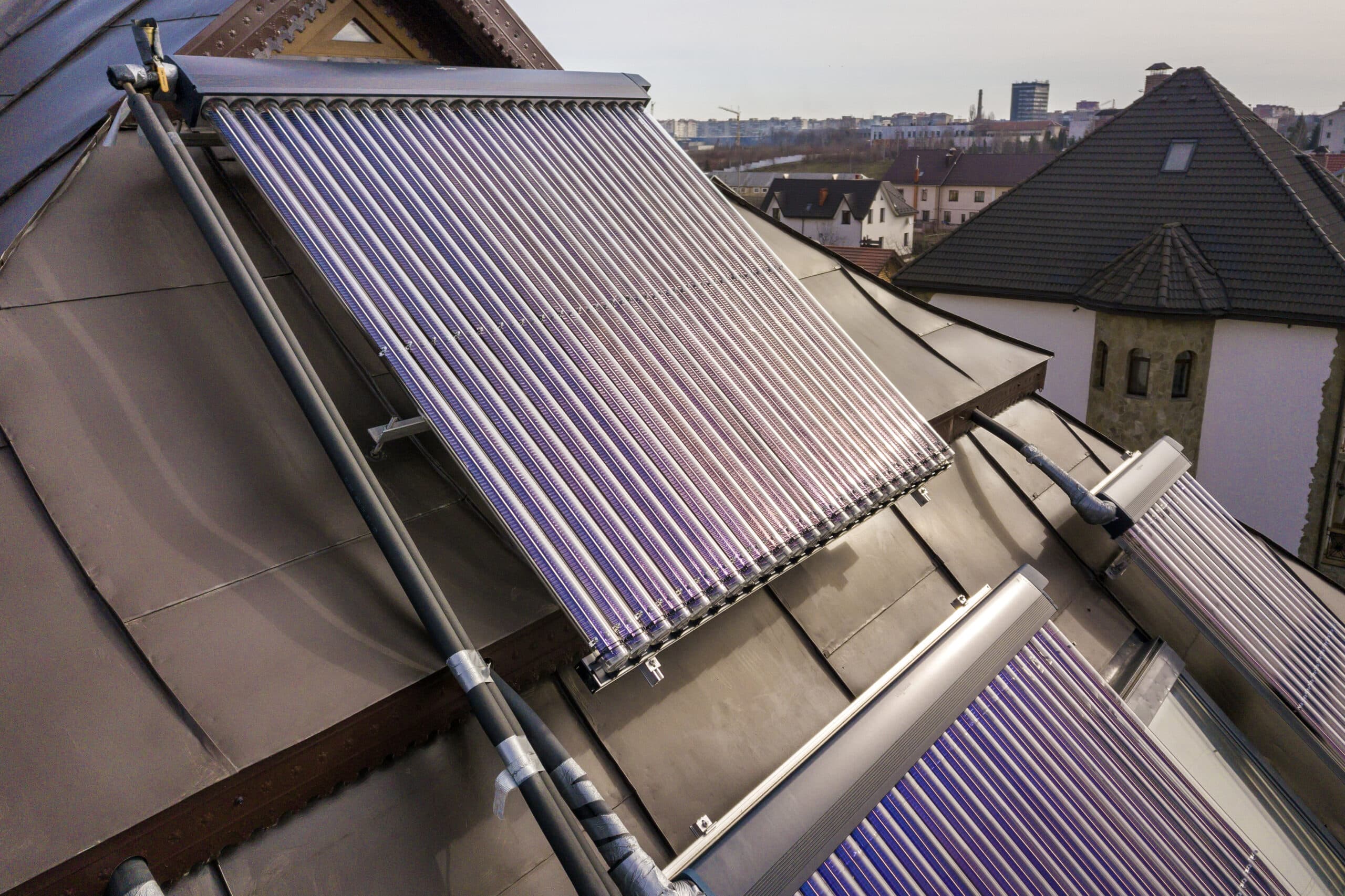 solar water heating system on house roof. hot water boiler, alternative ecological sun energy generator. modern technology concept.
