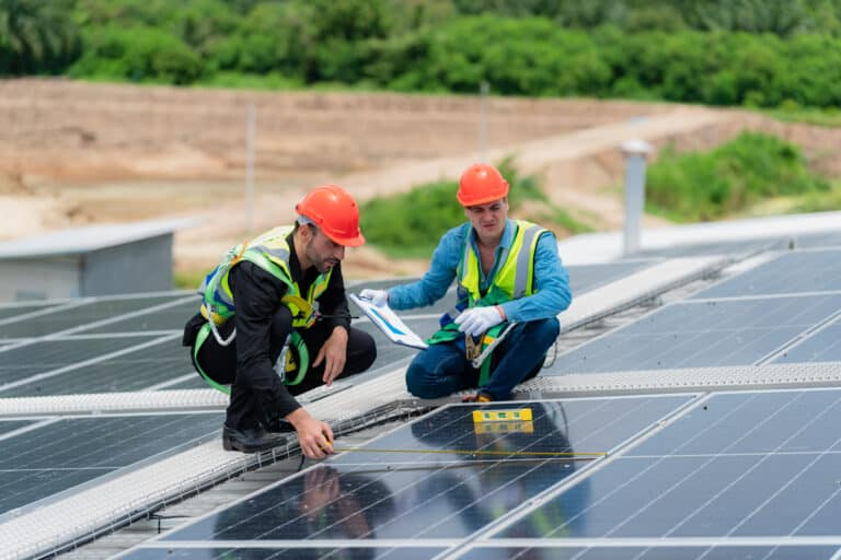 technician engineer team working to service and maintenance solar panel power system on rooftop