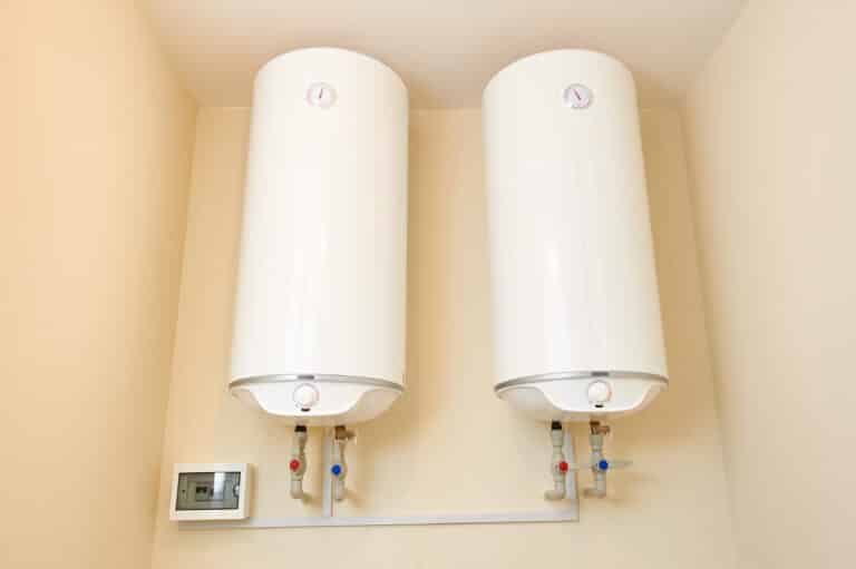 two electric water heaters on the wall. home wall mounted two water heating boilers.