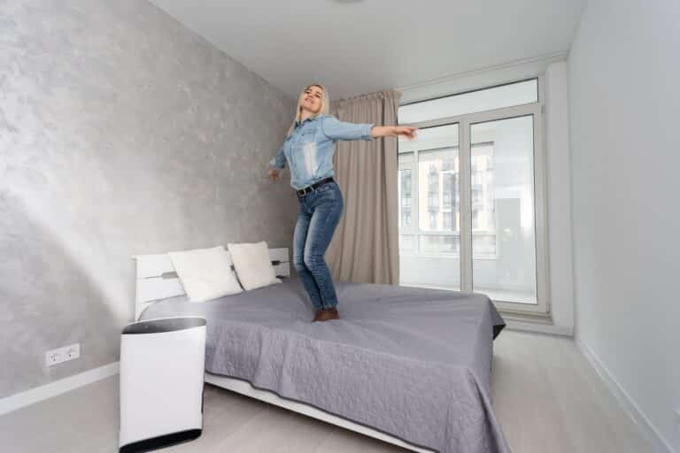 woman in living room using air cleaner and humidifier