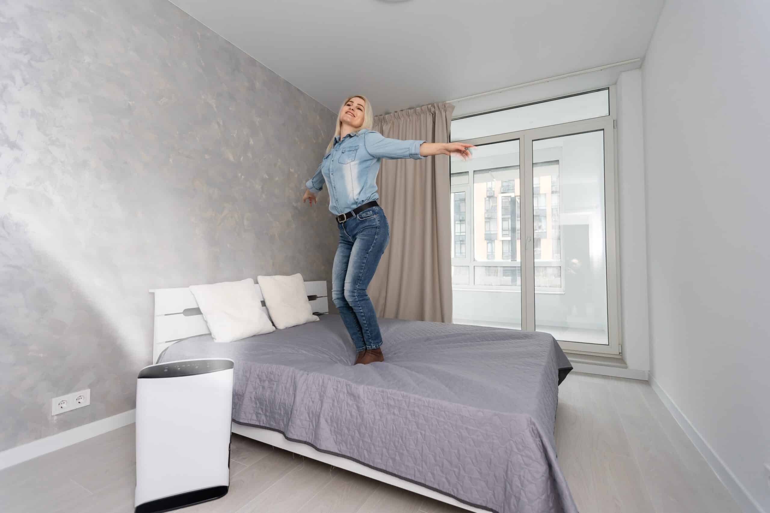 woman in living room using air cleaner and humidifier