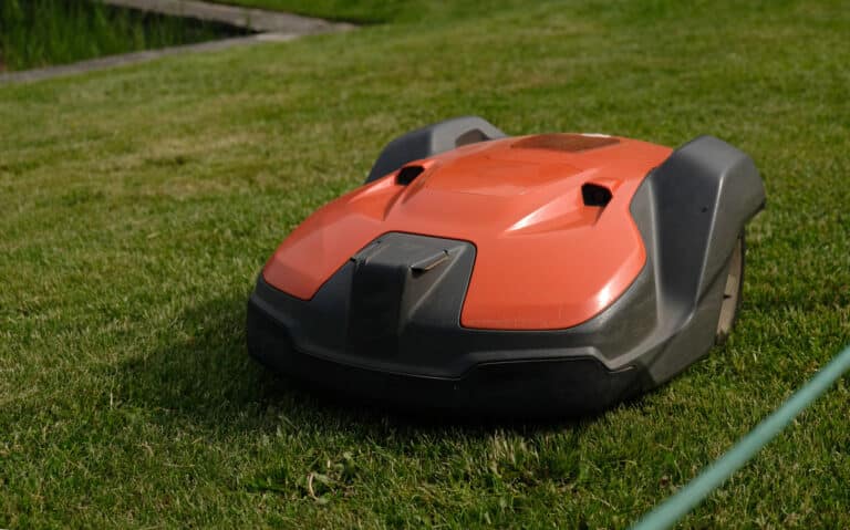 robotic lawn mower on green grass background autom 2022 10 21 21 09 37 utc