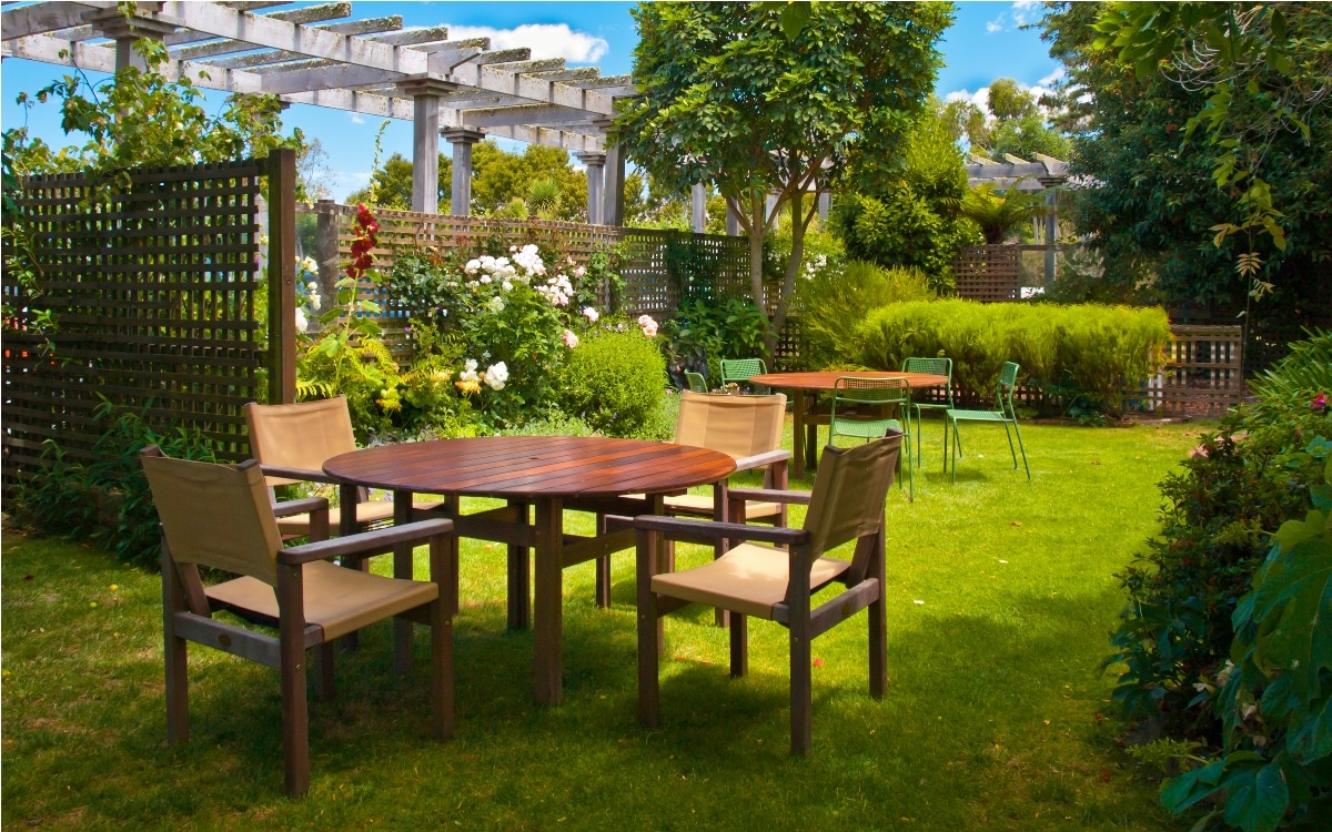 dining table set in lush landscaped garden