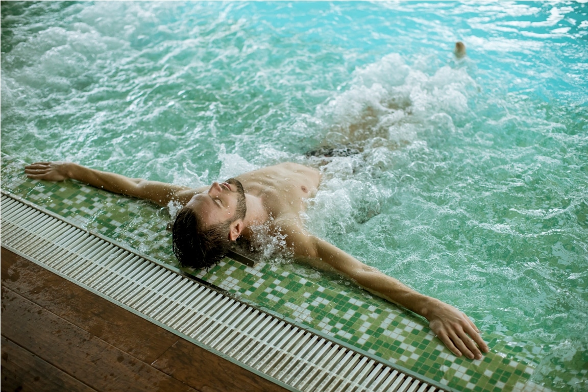 handsome young man relaxing in hot tub