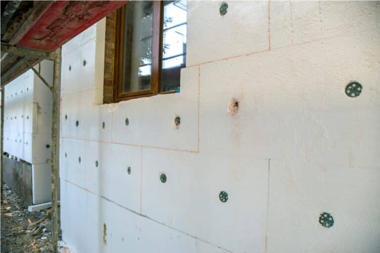 insulation work of house walls with styrofoam sheets.