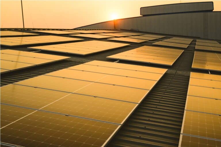 photovoltaic solar panels on rooftop with sunset at solar cell farm