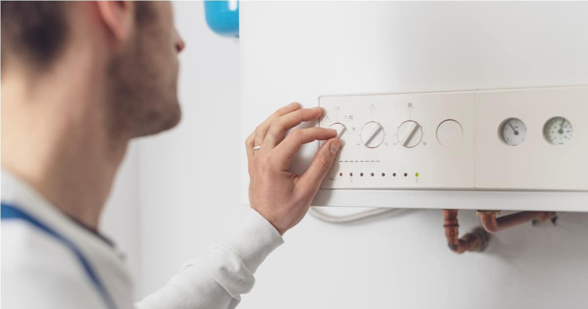 professional plumber checking a boiler control panel