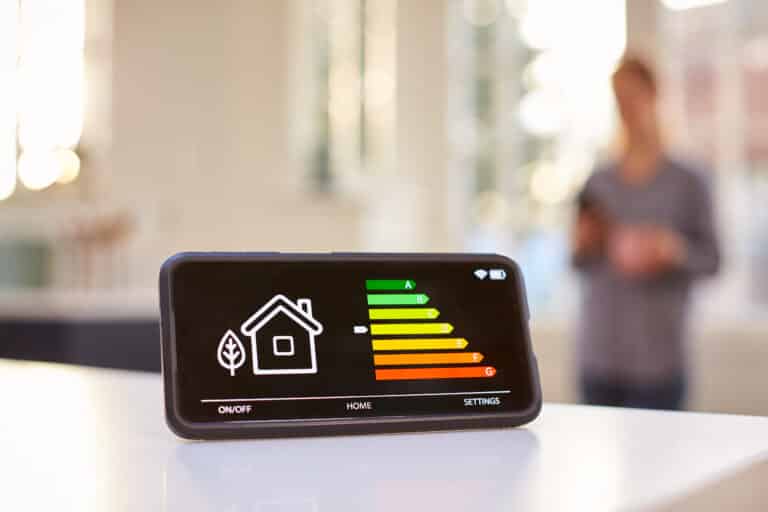 smart energy meter in kitchen measuring energy efficiency with figure in background