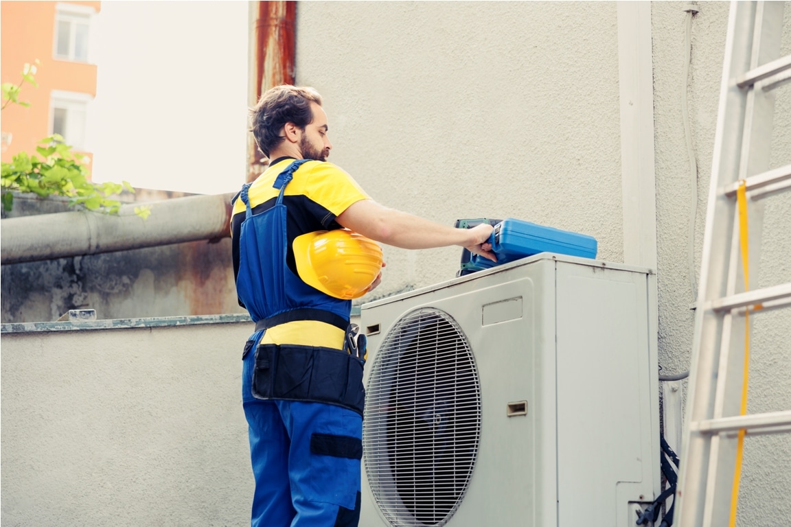 technician fixing air conditioner