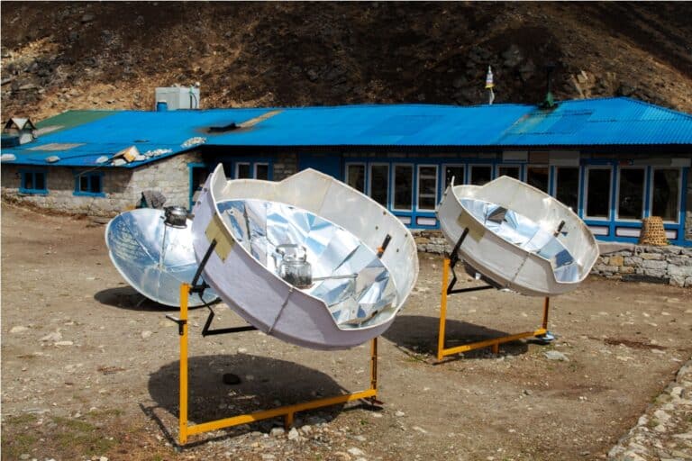 warming the teapot in a solar cooker. nepal. himalaya