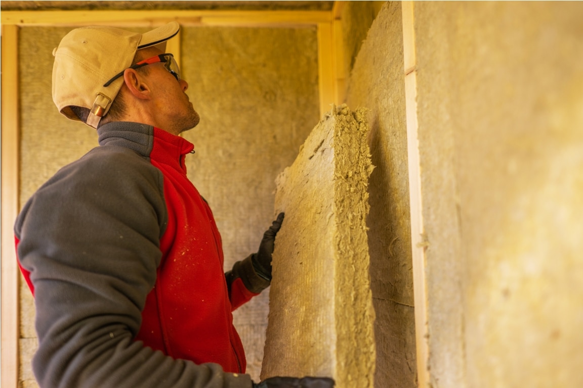 contractor installing mineral wool insulation