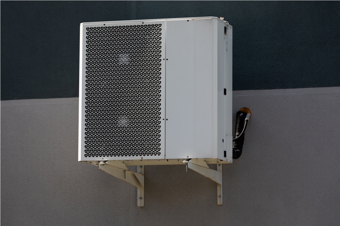 cooling unit for duct air conditioner hanging on the wall of the building.