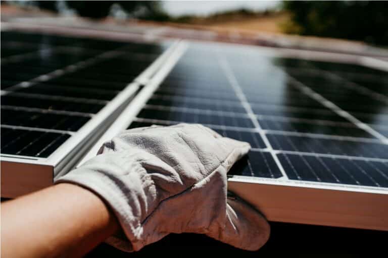 hand of technician touching solar panels on house 2022 10 11 20 20 49 utc