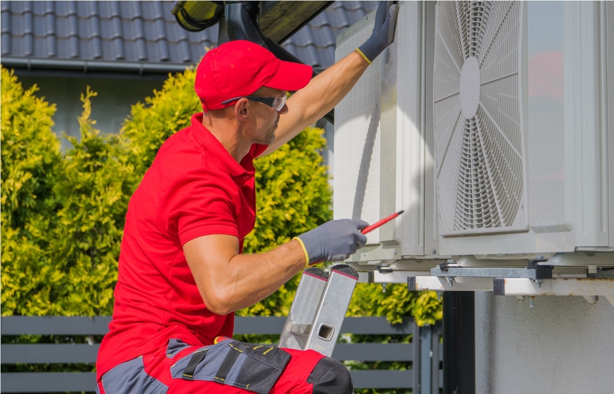 residential air conditioning maintenance technician at work