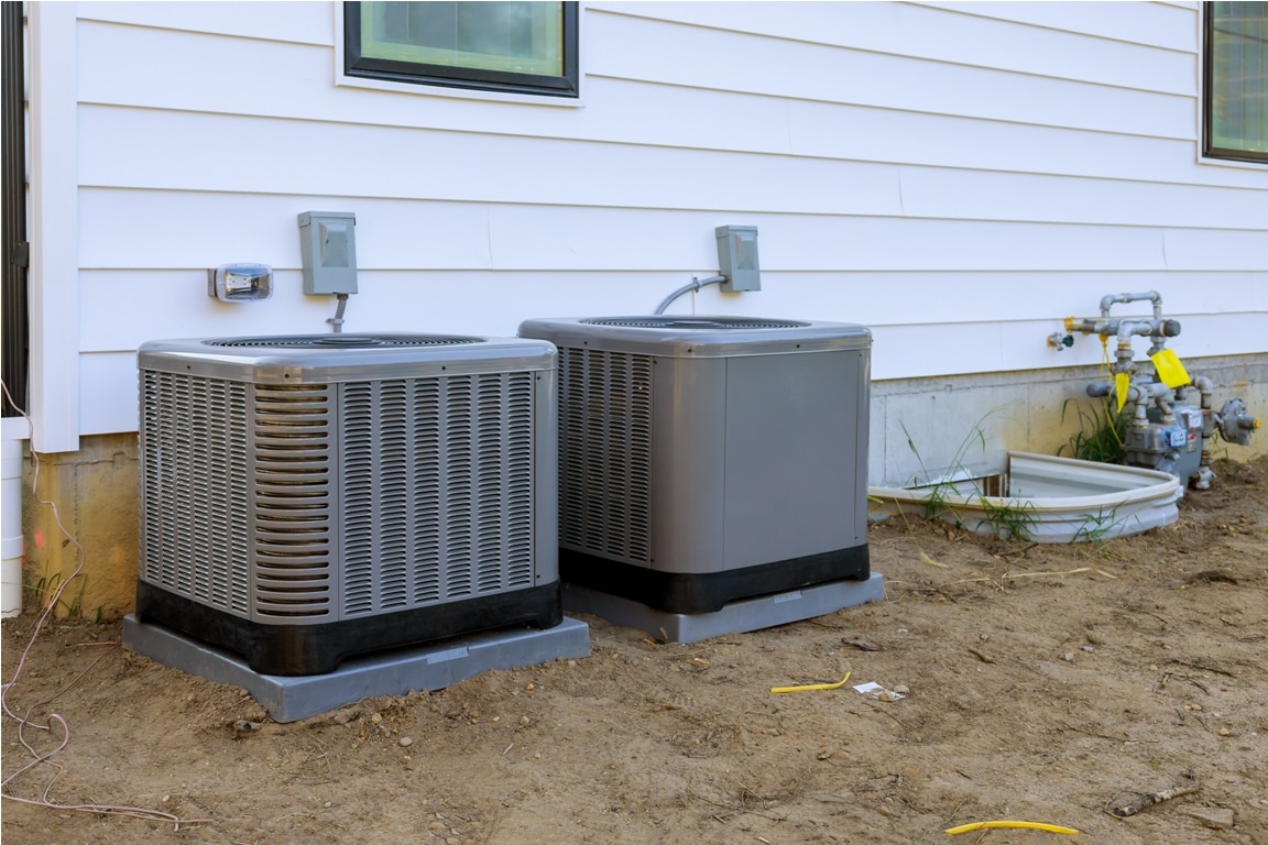 air conditioning system unit installed outside facade of the new house