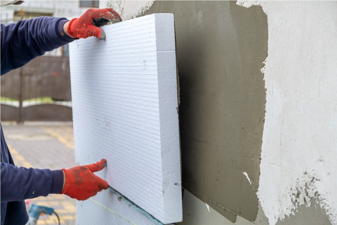 construction worker installing styrofoam insulatio 2022 02 08 18 13 41 utc