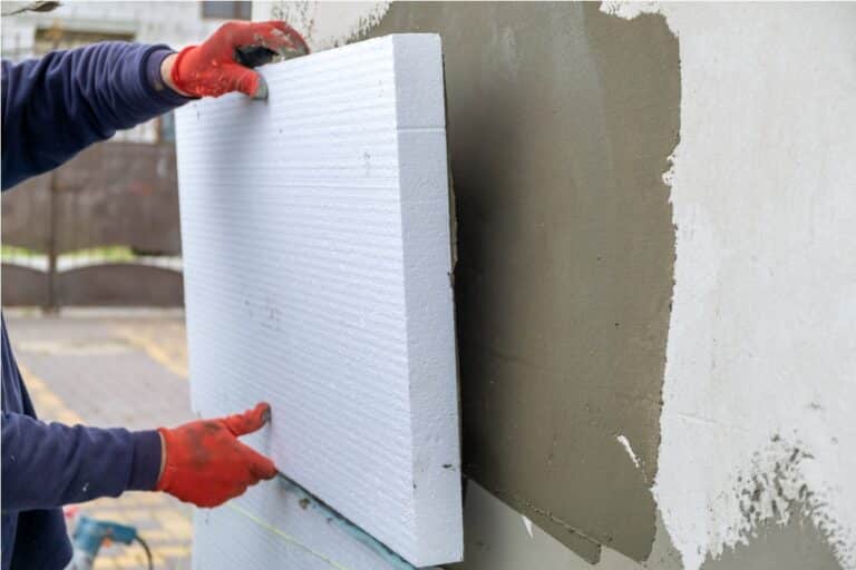 construction worker installing styrofoam insulatio 2022 02 08 18 13 41 utc