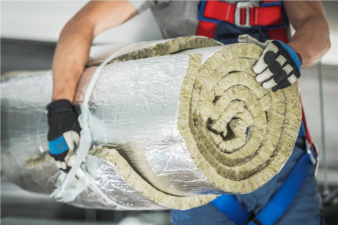 contractor worker with roll of mineral wool insulation