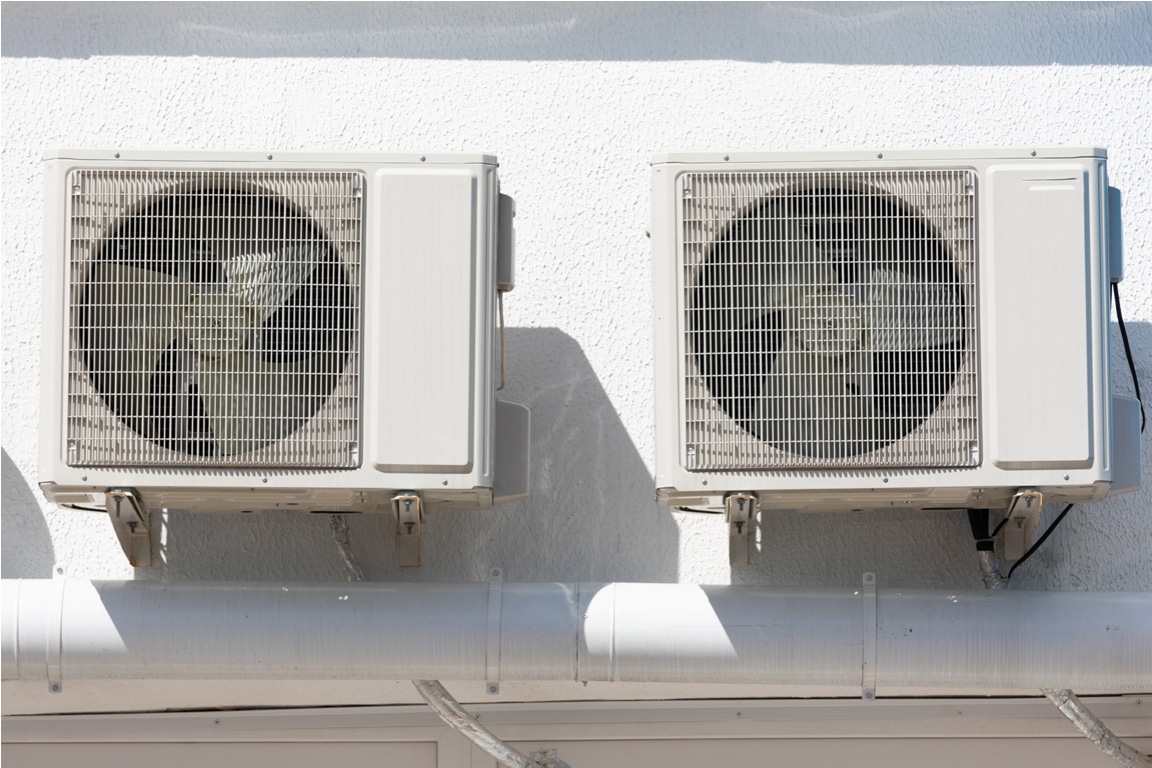 cooling unit for duct air conditioner hanging on the wall of the building.