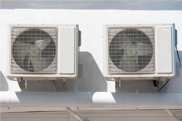 cooling unit for duct air conditioner hanging on the wall of the building.