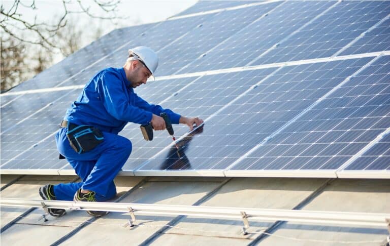 electrician mounting solar panel on roof of modern 2022 05 16 16 02 21 utc