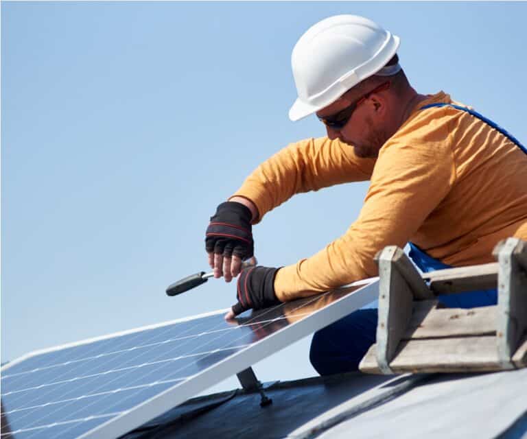 electrician mounting solar panel on roof of modern 2022 05 16 16 02 27 utc