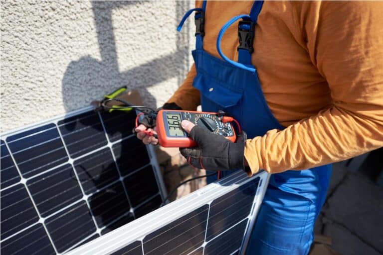 electrician mounting solar panel on roof of modern 2022 05 16 16 02 28 utc