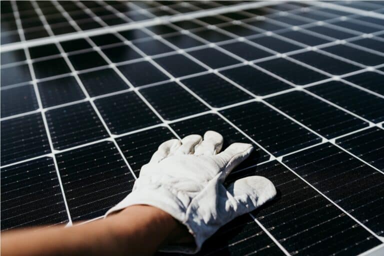 hand of technician touching solar panels on house 2022 10 11 20 15 29 utc