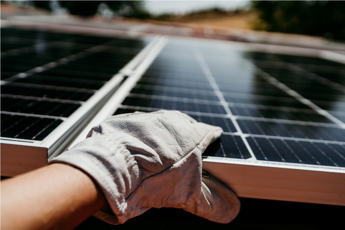 hand of technician touching solar panels on house 2022 10 11 20 20 49 utc