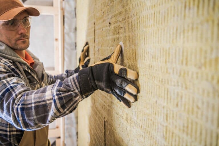 construction contractor worker finishing mineral wool insulation installing.