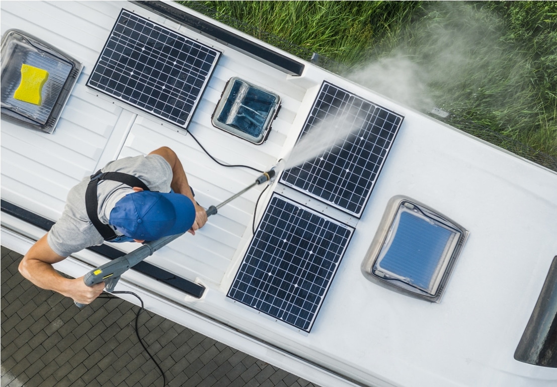 men power washing his camper van rv roof and solar panels