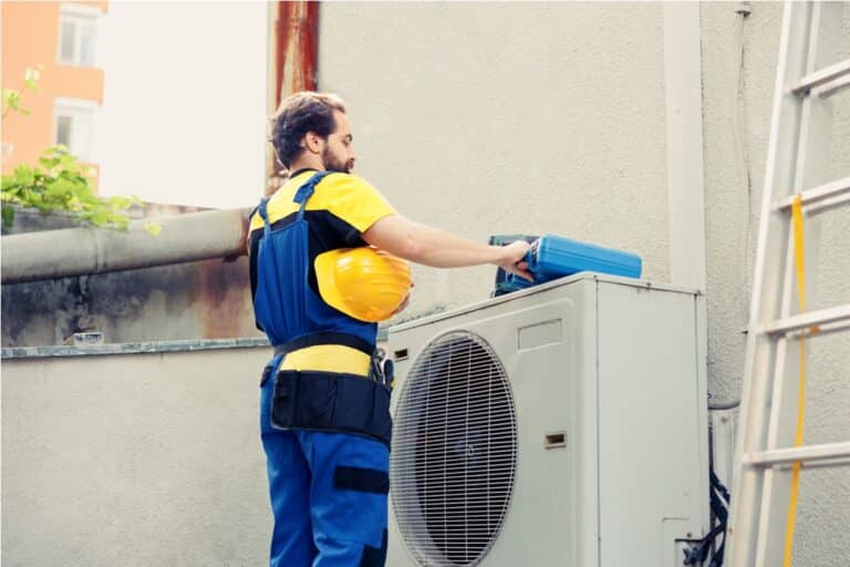 technician fixing air conditioner