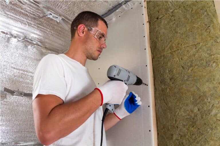 worker in goggles with screwdriver working on insu 2023 05 09 19 18 41 utc