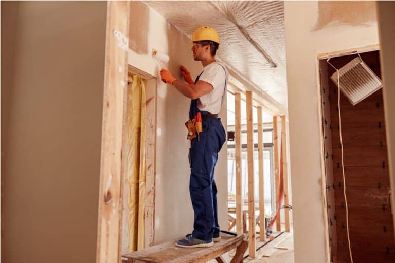 male builder painting wall in house under construc 2023 11 27 05 26 03 utc