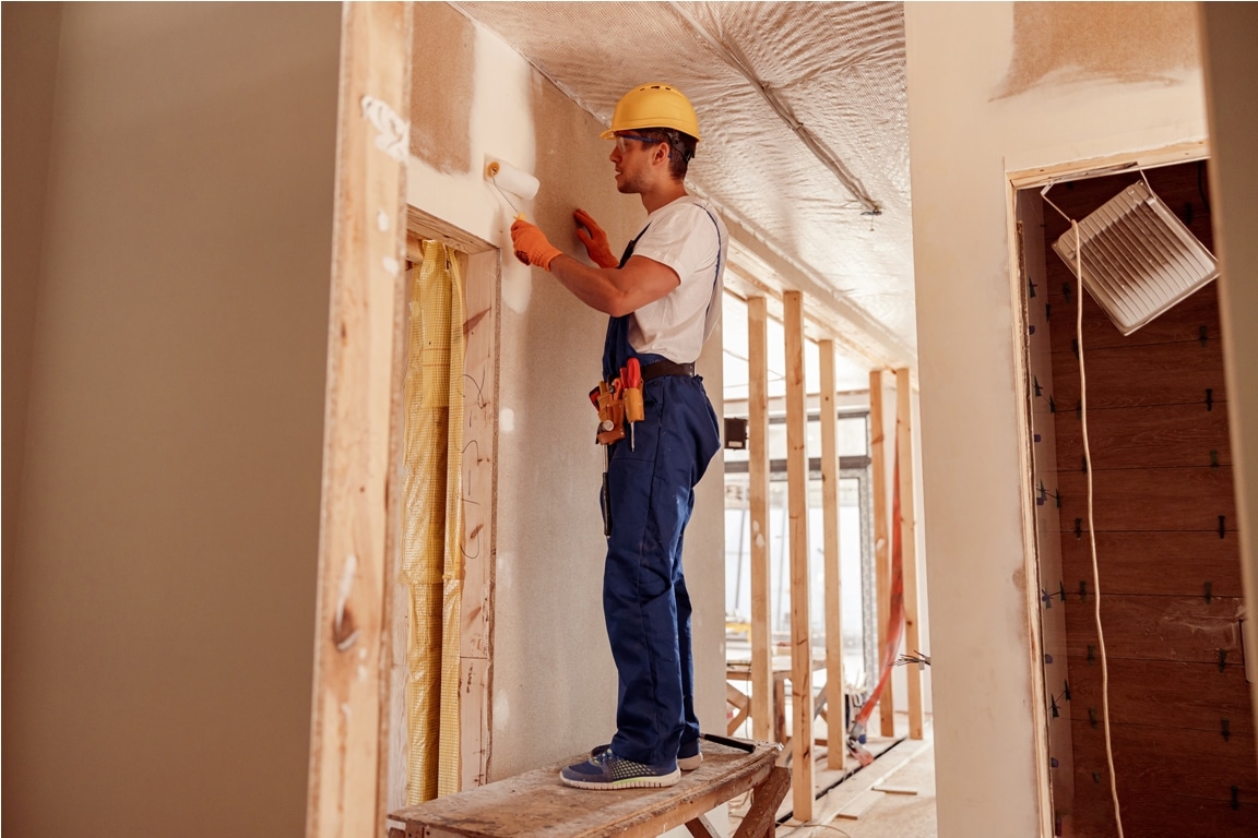 male builder painting wall in house under construc 2023 11 27 05 26 03 utc