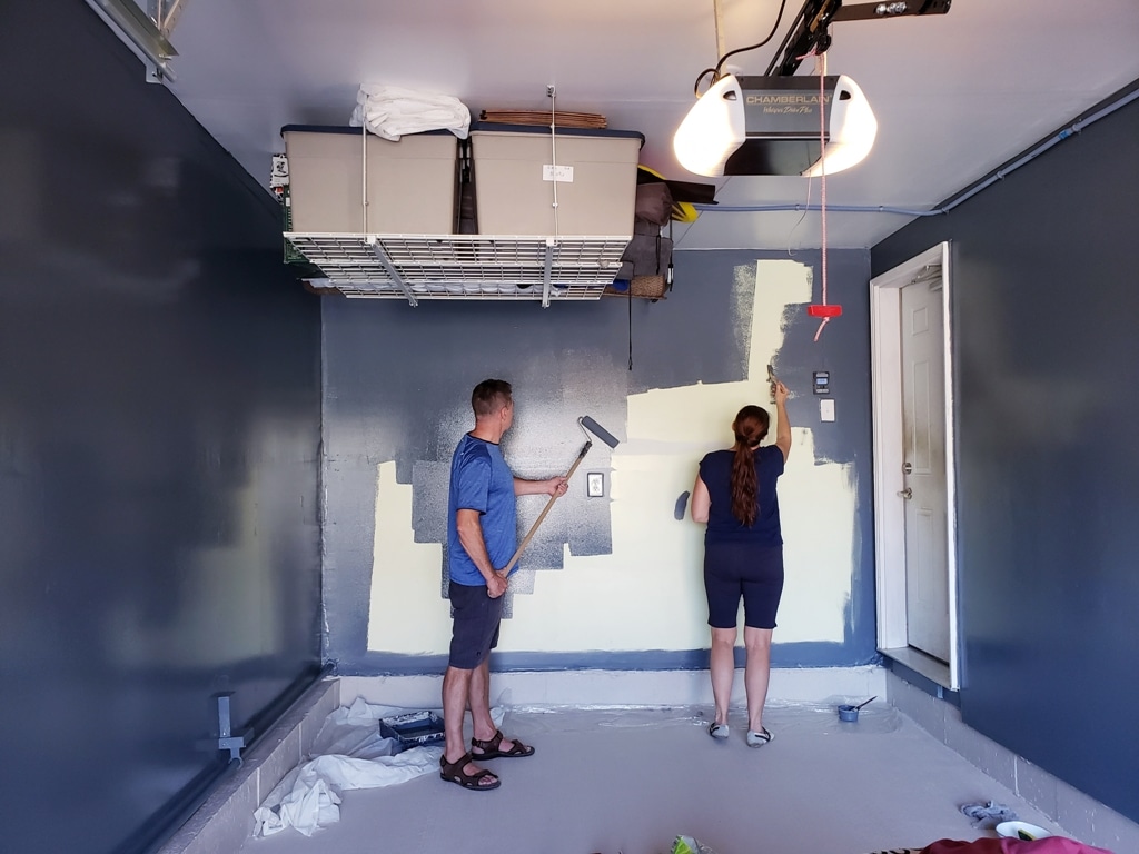 two painters in the garage painting walls small b 2023 11 27 04 59 58 utc